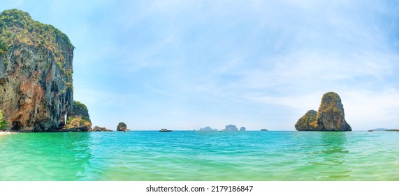Tropical beach panorama landscape with clear water, rocky mountain and island in sea. Phra Nang beach, Thailand