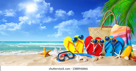 Tropical Beach With Sunbathing Accessories, Summer Holiday Background. Travel And Beach Family Vacation