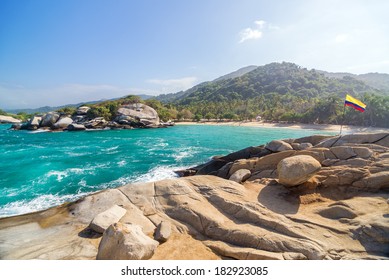 Tropical Beach In Tayrona National Park In Colombia With A Colombian Flag Visible