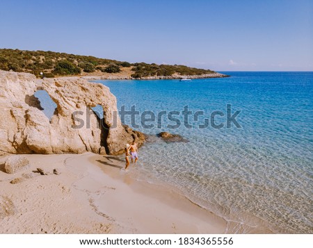 Tropical beach of Voulisma beach, Istron, Crete, Greece ,Most beautiful beaches of Crete island -Istron bay near Agios Nikolaos drone aerial view, couple walking on the ebach