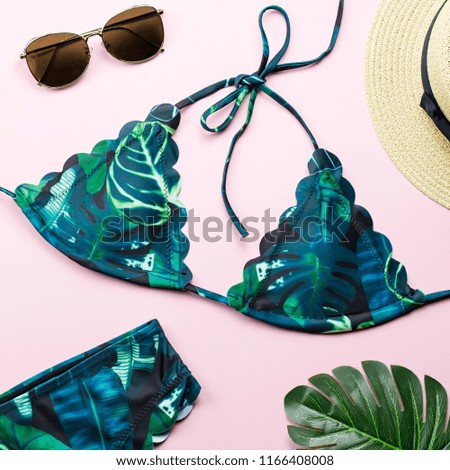 Tropical bikini swimsuit, beach fashion. Traveler woman accessories flat lay with swimwear, palm leaves.