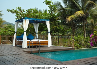 Tropical Cabana Stands Beside A Swimming Pool