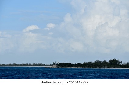 Tropical Coastal Landscape with Clear Blue Water and Lush Vegetation and Beautiful Clouds - Powered by Shutterstock