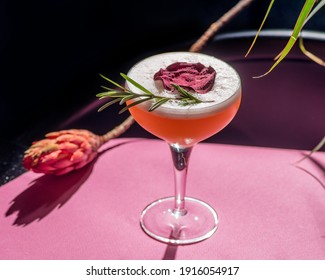 Tropical Cocktail On A Background Of Foliage, Shadows From The Sun. Pink Background