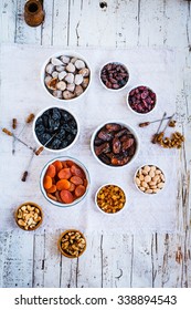 Tropical Dried Fruits Figs, Apricot, Plums, Nuts, Raisins, Date Palm Three Fruit  In White Bowl Over Old Linen Napkin. Middle Eastern Dried Fruits For Dessert.  
