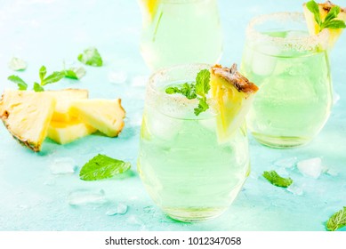 Tropical Drink, Pineapple Juice Margarita Cocktail With Fresh Mint, Light Blue Background Copy Space