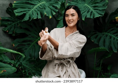 Tropical and exotic spa garden with bathtub in modern hotel or resort with woman in bathrobe holding beauty skincare product while enjoying leisure lush with greenery foliage background. Blithe - Shutterstock ID 2393897117