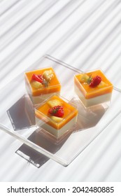 Tropical Fruit Panna Cotta, In Square Shot Glasses, On White Background.