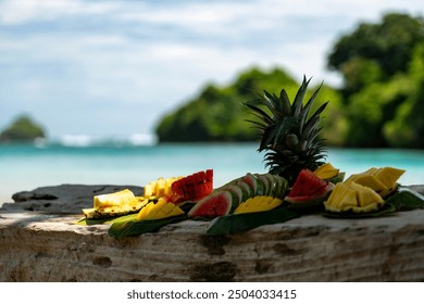 Tropical Fruit Platter on a Sandy Beach with Fresh Pineapple, Watermelon, and Mango, Capturing Island Life and Coastal Relaxation in a Vibrant, Exotic Paradise During a Summer Vacation Getaway - Powered by Shutterstock