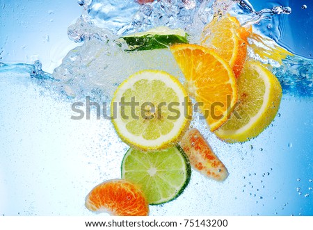 tropical fruits fall deeply under water with a big splash