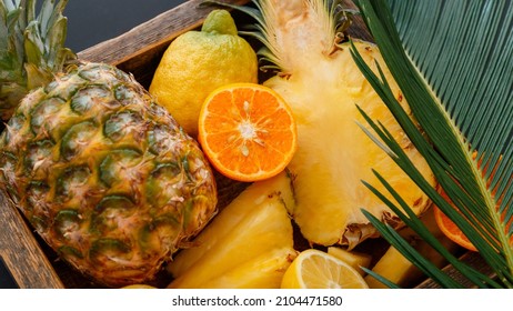 Tropical fruits Mix box and palm leaves. Tangerines oranges pineapples lemons. Tropical citrus vitamin dessert as summer background. Long web banner - Powered by Shutterstock