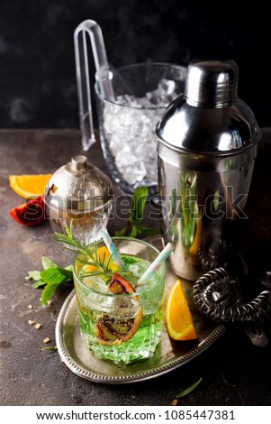 tropical green cocktail with lemon and fresh rosemary