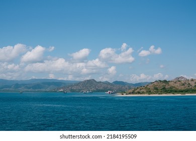 Tropical Green Hill Near Sea Harbor With Blue Sky Background