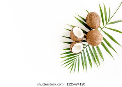 Tropical Green Palm Leaf, Cracked Coconut On White Background.  Nature Concept. Flat Lay, Top View