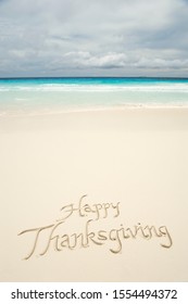 Tropical Happy Thanksgiving Travel Message Handwritten In Calligraphy On Smooth Sand Beach