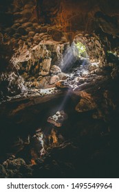 Tropical Holiday Destination. South East Asian Travel Destination. Halong Bay Caves, Vietnam. Sun Beam Through Cave. Tropical Tourist Vacation. 