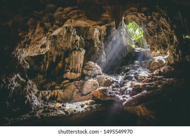 Tropical Holiday Destination. South East Asian Travel Destination. Halong Bay Caves, Vietnam. Sun Beam Through Cave. Tropical Tourist Vacation. 