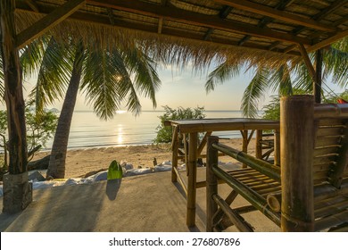 Tropical Island Hut On Beach At Sunset