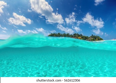 Tropical Island On Indian Ocean, Maldives. Half Underwater Shot, Clear Turquoise Water