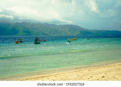 Tropical island with white sandy beach and blue transparent water. Copy space for text : Lombok Indonesia 6 March 2021