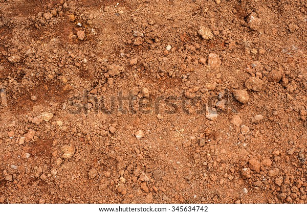 Tropical laterite soil or red earth\
background. Red mars seamless sand background. Top view\
