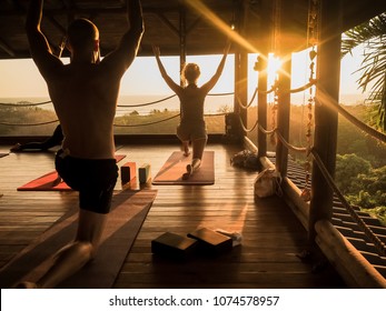 tropical open yoga studio place with people and a view outside to the ocean while sunset
 - Powered by Shutterstock