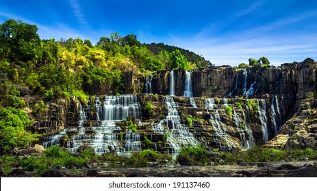 Tropical Rainforest Landscape Panorama With Flowing Pongour Waterfall Under Blue Sky. Da Lat, Vietnam