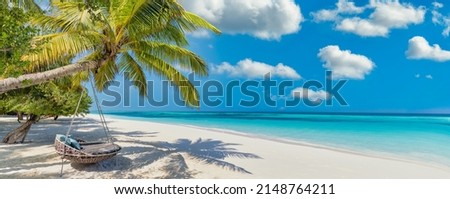 Tropical relax beach as summer island landscape with beach swing or hammock on palm, close to fantastic sea view. Amazing beach panorama vacation and summer holiday concept. Luxury panoramic travel