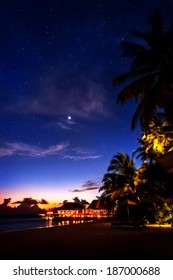 Tropical resort at night, beautiful nighttime scene of a romantic beach, peaceful island landscape