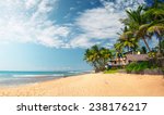 Tropical sandy beach with palm trees. Hikkaduwa, Sri Lanka