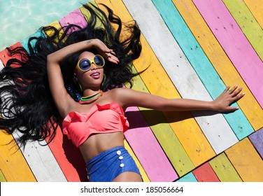 Tropical Summer Holiday Fashion Concept - Tanning Woman On A Wooden Pier