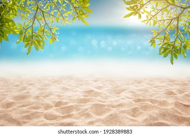 Tropical summer sandy beach focus area at sand floor and bokeh sun light on blurry sea and sky montage photo with plumeria branch as frame