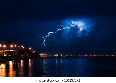 Tropical thunderstorm at night over Miami with massive lightning bolt