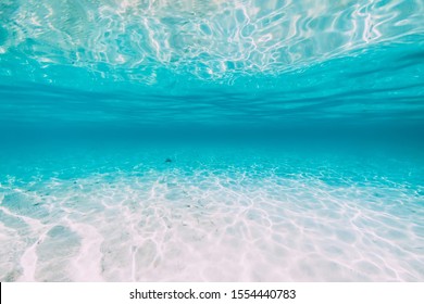 Tropical transparent ocean with white sand and water reflection underwater in Hawaii
