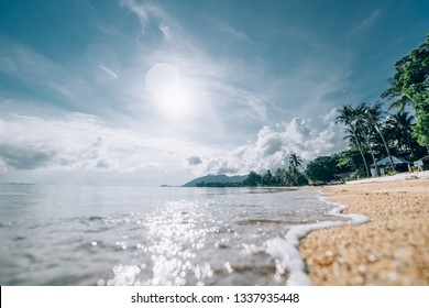 Tropical utterance landscape. Sea coast at sunrise. The sun rises over a sandy deserted beach on a tropical island. - Shutterstock ID 1337935448