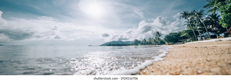 Tropical utterance landscape. Sea coast at sunrise. The sun rises over a sandy deserted beach on a tropical island. - Shutterstock ID 1924516706