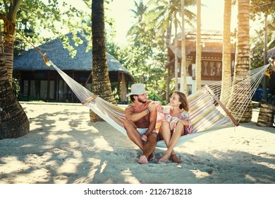 Tropical Vacation. Young Family Couple Relaxing On Hammock In Beach Resort.