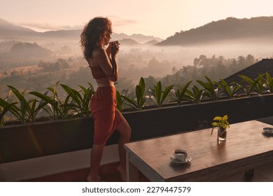 Tropical Woman Drink Tea. Beautiful Lady Drinking Coffee At Terrace Enjoying Green Nature Views. Tanned Girl In Red Clothes Relaxing Outdoors  - Powered by Shutterstock