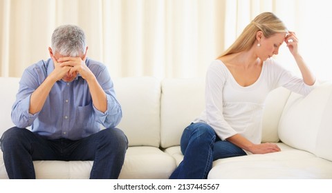 Trouble In Paradise. Mature Married Couple Sitting On The Sofa And Having A Disagreement.