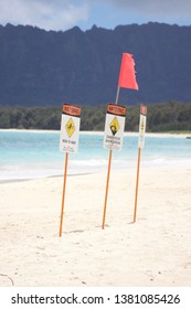 Trouble In Paradise; Multiple Warning Signs On A Beautiful And Secluded White Sandy Beach.