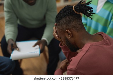 Troubled black man crying in support group circle and sharing story with therapist, copy space - Powered by Shutterstock