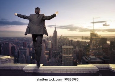 Troubled Businessman Jumping From The Top Of A Building