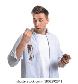 Troubled Man In Dirty Clothes Eating Chocolate Cake On White Background