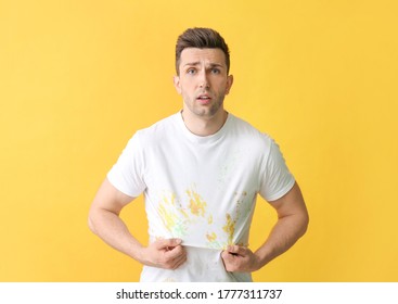 Troubled Man In Dirty Clothes On Color Background