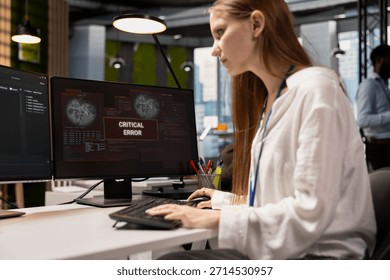 Troubled software developer reviewing error logs at work, trying to to resolve critical glitches. Tense young inexperienced worker debugging code in office, looking for solutions to fix errors