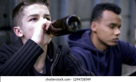 Troubled teenage friends skipping classes and drinking alcohol, youth problems