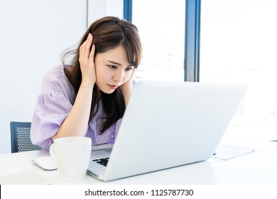 Troubled woman in the office. - Shutterstock ID 1125787730