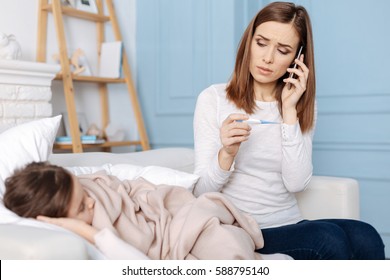 Troubled Young Mother Calling A Doctor