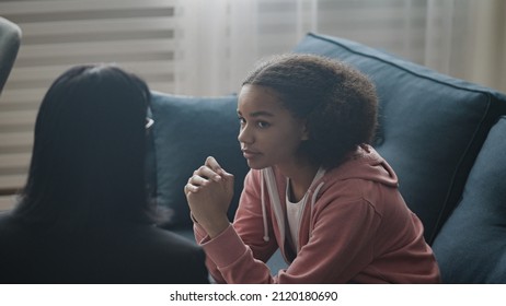 Troubled youth counselor discussing problem with teen girl, psychological support - Shutterstock ID 2120180690