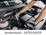 Troubleshooting process. Auto mechanic working in garage. Repair service.